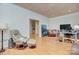 The office features hardwood floors, a sitting area, a large desk with computer, and an adjoining room at 4323 Rosecliff Dr, Charlotte, NC 28277