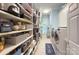 Well-stocked pantry with ample shelving for organized storage, adjacent to a modern laundry area at 4323 Rosecliff Dr, Charlotte, NC 28277