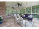 Inviting screened-in porch featuring a comfortable seating area and dining area, with overhead string lights and ceiling fans at 4323 Rosecliff Dr, Charlotte, NC 28277