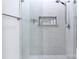 This walk-in shower is enclosed in glass, is trimmed in marble, and includes shampoo niche at 4323 Rosecliff Dr, Charlotte, NC 28277