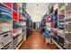 Large walk-in closet with custom shelving and a central bench, ideal for organizing clothing and accessories at 4323 Rosecliff Dr, Charlotte, NC 28277