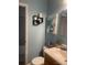 Comfortable bathroom featuring blue walls and decorative boat artwork above the toilet at 4337 Gelinda Ct, Gastonia, NC 28056