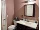 Bathroom with modern lighting, dark vanity, and pink walls at 4337 Gelinda Ct, Gastonia, NC 28056