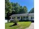 Charming ranch-style home with a covered porch and a well-manicured lawn surrounded by lush trees at 4337 Gelinda Ct, Gastonia, NC 28056