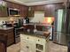 Modern kitchen with stainless steel appliances, an island, and dark wood cabinets at 4337 Gelinda Ct, Gastonia, NC 28056