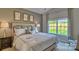 Bright bedroom featuring a large window with backyard views and a stylishly decorated neutral color palette at 4607 Harris Elliot Rd, Lincolnton, NC 28092