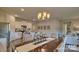 Open concept dining room adjacent to kitchen with modern light fixture at 4607 Harris Elliot Rd, Lincolnton, NC 28092