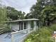 Exterior view of a rundown building with overgrown greenery and a dilapidated deck, hinting at deferred maintenance at 528 Waring Ct # Lot 3, Fort Mill, SC 29707