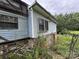 Exterior view of a weathered home with stone foundation and overgrown foliage at 528 Waring Ct # Lot 3, Fort Mill, SC 29707