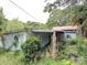 Exterior view of a dilapidated home surrounded by lush greenery, featuring a unique round window at 528 Waring Ct # Lot 3, Fort Mill, SC 29707