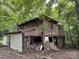 Exterior view of a dilapidated two-story home with wood siding surrounded by trees at 528 Waring Ct # Lot 3, Fort Mill, SC 29707