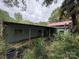 Exterior view of a single-story home with a covered porch, showing signs of neglect, and overgrown vegetation at 528 Waring Ct # Lot 3, Fort Mill, SC 29707