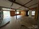 Interior of a living room with wood paneled walls and exposed beams, showing signs of damage and disrepair at 528 Waring Ct # Lot 3, Fort Mill, SC 29707