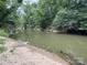A scenic view of a creek with sandy shore surrounded by lush trees at 528 Waring Ct # Lot 3, Fort Mill, SC 29707