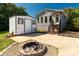 Backyard with a fire pit, outdoor shed, grass area, and stairs to the house at 5323 Flat Creek Rd, Heath Springs, SC 29058