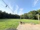Landscaped backyard featuring string lights, a large lawn, and tree line at 5323 Flat Creek Rd, Heath Springs, SC 29058