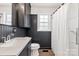 Stylish bathroom featuring a vanity with white countertops, dark wood walls, and shower at 5323 Flat Creek Rd, Heath Springs, SC 29058