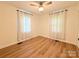 Bright bedroom features wood-look flooring, two windows and ceiling fan at 5323 Flat Creek Rd, Heath Springs, SC 29058