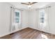 Bedroom with light walls, laminate floors, and white curtains at 5323 Flat Creek Rd, Heath Springs, SC 29058