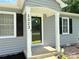 A welcoming home entrance showcasing gray siding, black shutters, and decorative wreath at 5323 Flat Creek Rd, Heath Springs, SC 29058