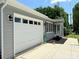 Home exterior shot highlighting the attached garage and manicured landscaping at 5323 Flat Creek Rd, Heath Springs, SC 29058