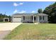 Attractive single-story home featuring gray siding, black shutters, and well-maintained landscaping at 5323 Flat Creek Rd, Heath Springs, SC 29058