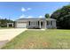 Well-kept home features an attached garage, neat landscaping, and a welcoming front entrance at 5323 Flat Creek Rd, Heath Springs, SC 29058