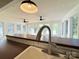 Bright kitchen features a long breakfast bar, white tiling, and plentiful natural light at 5323 Flat Creek Rd, Heath Springs, SC 29058