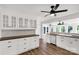 Kitchen featuring white cabinets, dark countertops, stainless appliances and wood flooring at 5323 Flat Creek Rd, Heath Springs, SC 29058