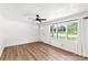 Bright living room featuring wood floors, neutral walls, and many windows for natural light at 5323 Flat Creek Rd, Heath Springs, SC 29058