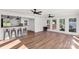 Open living room area featuring bar seating, wood floors, and lots of natural light at 5323 Flat Creek Rd, Heath Springs, SC 29058