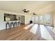 Spacious living room with wood floors, bar seating, and large windows at 5323 Flat Creek Rd, Heath Springs, SC 29058