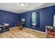 Bedroom with wood floors, window, and walk in closet at 5626 Sandhurst Rd, Hickory, NC 28602
