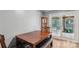 Simple dining area with wood table, gray walls, and a door to the outside at 5626 Sandhurst Rd, Hickory, NC 28602