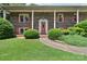 Up close view of the home's front entrance and door, framed by brick and shrubbery at 5626 Sandhurst Rd, Hickory, NC 28602