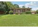 A beautiful two-story brick home boasting a large, lush front yard and landscaping at 5626 Sandhurst Rd, Hickory, NC 28602