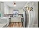 Bright kitchen with stainless steel refrigerator, white cabinetry, and ample counter space at 5626 Sandhurst Rd, Hickory, NC 28602