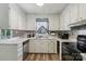 Bright kitchen with stainless steel appliances, white cabinetry, and ample counter space at 5626 Sandhurst Rd, Hickory, NC 28602