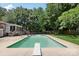 Backyard swimming pool with a diving board, ladder and deck surrounded by privacy fence and trees at 5626 Sandhurst Rd, Hickory, NC 28602