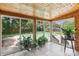 Sunroom with tile floors and views of the backyard and swimming pool at 5626 Sandhurst Rd, Hickory, NC 28602