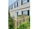 Private backyard featuring a white picket fence, blooming flowers, and an outdoor seating area at 5947 Quail Hollow Rd # A, Charlotte, NC 28210