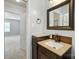 Bathroom vanity with bronze faucet, large mirror, and view into adjacent bedroom at 5947 Quail Hollow Rd # A, Charlotte, NC 28210
