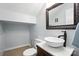 Stylish powder room boasts a vessel sink, elegant mirror, and neutral tile flooring at 5947 Quail Hollow Rd # A, Charlotte, NC 28210
