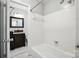 Full bathroom with tiled bathtub and shower combo, vanity, and updated fixtures at 5947 Quail Hollow Rd # A, Charlotte, NC 28210