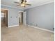 Spacious bedroom with neutral carpet, ceiling fan, and ensuite bathroom at 5947 Quail Hollow Rd # A, Charlotte, NC 28210