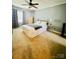 Comfortable bedroom with neutral carpet, a ceiling fan, and light-filled window at 5947 Quail Hollow Rd # A, Charlotte, NC 28210