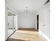 Bright dining room with hardwood floors, modern chandelier, and sliding door to the exterior at 5947 Quail Hollow Rd # A, Charlotte, NC 28210