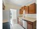 Bright kitchen features wood cabinets, white tile backsplash, and stainless steel dishwasher at 5947 Quail Hollow Rd # A, Charlotte, NC 28210