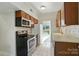 Efficient kitchen features stainless steel appliances, tiled backsplash, and ample cabinet space at 5947 Quail Hollow Rd # A, Charlotte, NC 28210