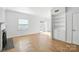 Bright living room with hardwood floors, built in shelving and sliding glass doors to the exterior at 5947 Quail Hollow Rd # A, Charlotte, NC 28210